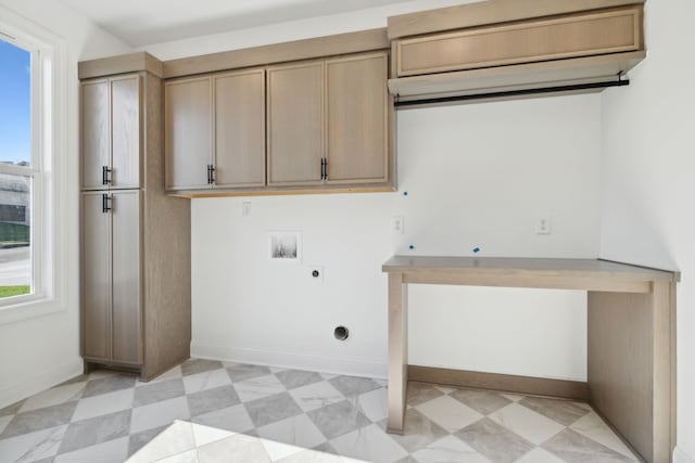 washroom with hookup for an electric dryer, washer hookup, a healthy amount of sunlight, and cabinets