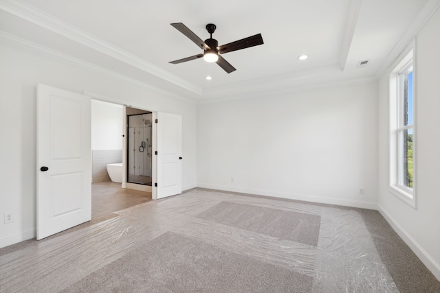 carpeted empty room with a tray ceiling, ceiling fan, and crown molding