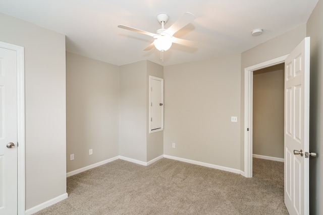 unfurnished bedroom featuring light carpet and ceiling fan