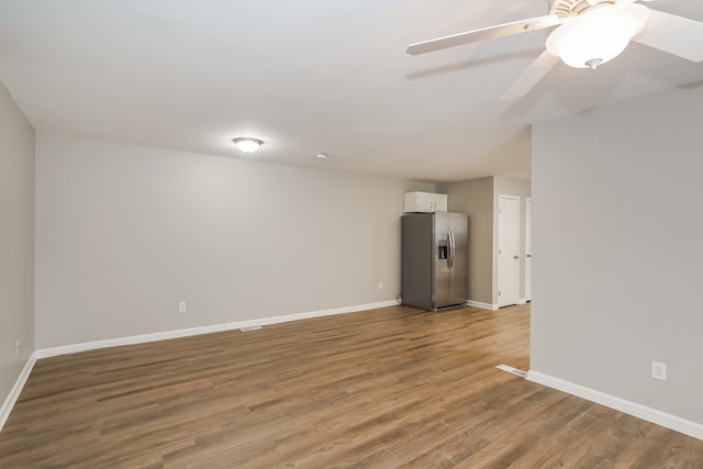 empty room with light hardwood / wood-style flooring and ceiling fan