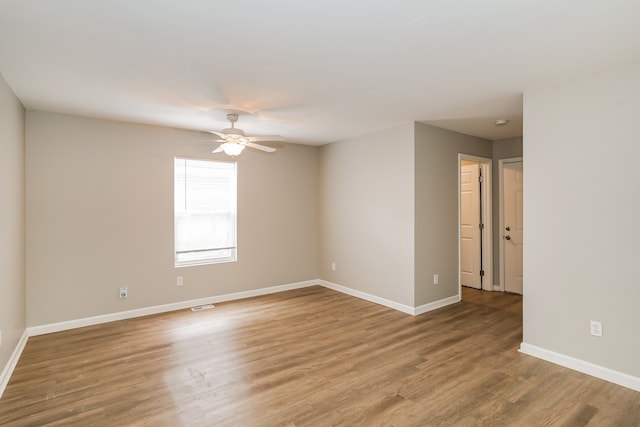 empty room featuring light wood-type flooring and ceiling fan