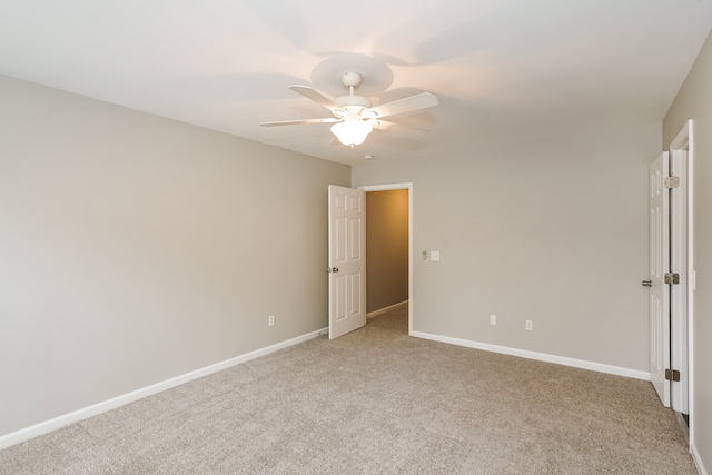 unfurnished bedroom featuring ceiling fan and light carpet