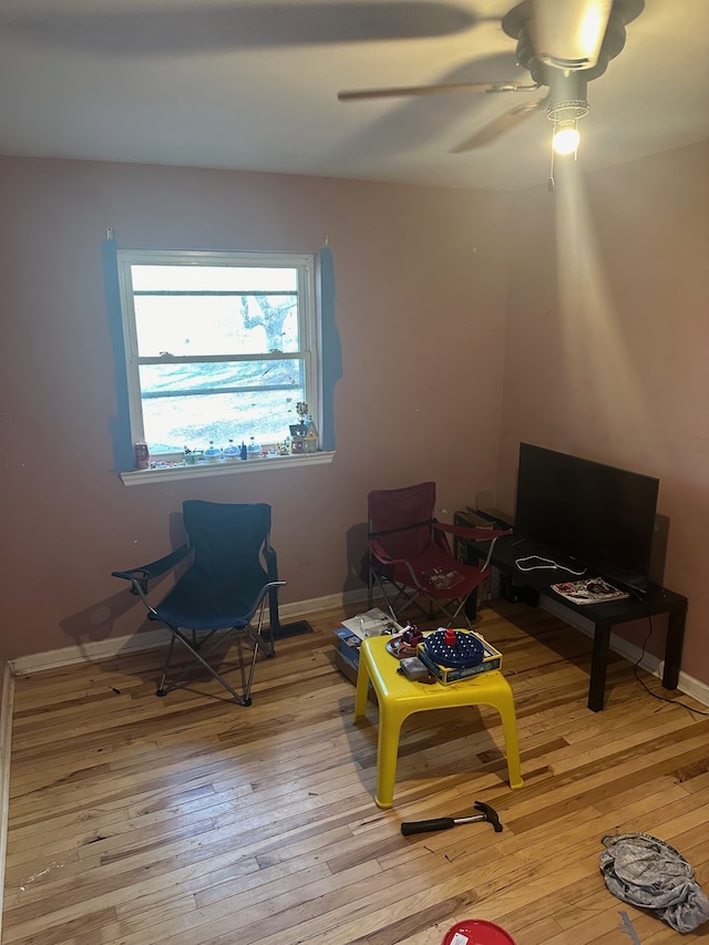 sitting room with light wood-type flooring and ceiling fan