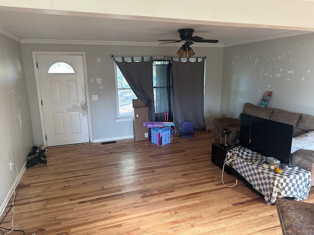 entrance foyer featuring wood-type flooring, ceiling fan, and crown molding