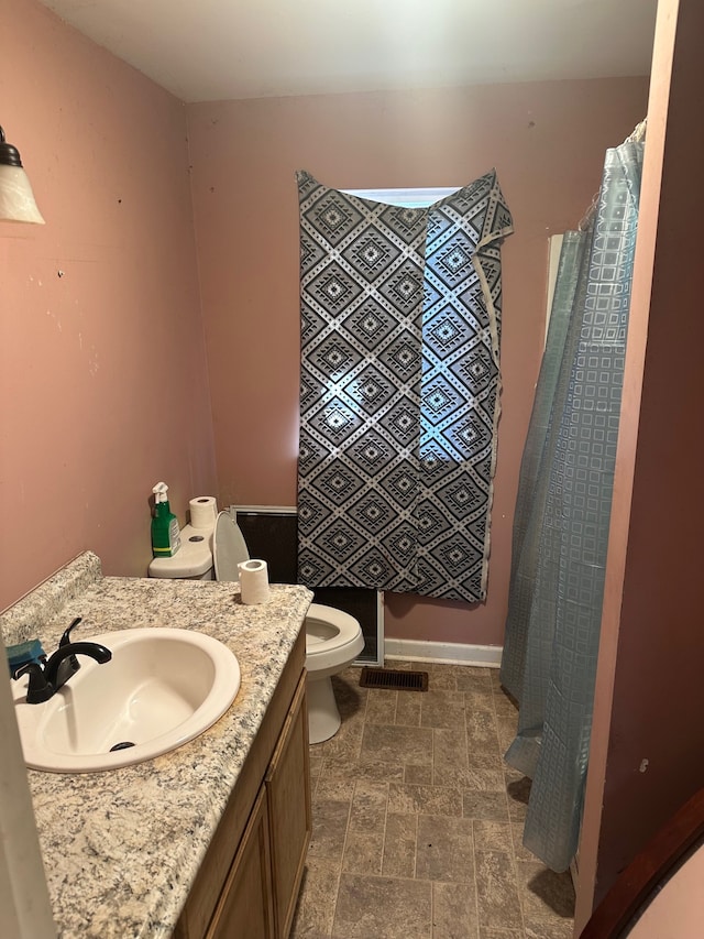 bathroom with toilet and vanity