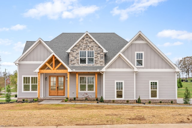 craftsman-style house with french doors and a front lawn