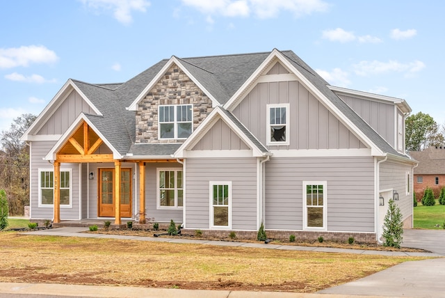 craftsman-style house with covered porch and a front yard