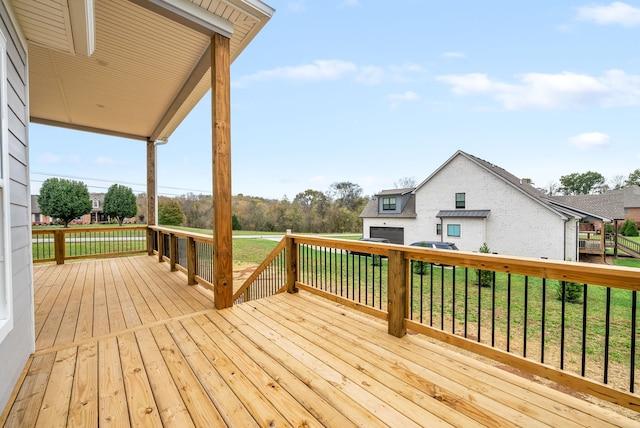 wooden terrace featuring a yard