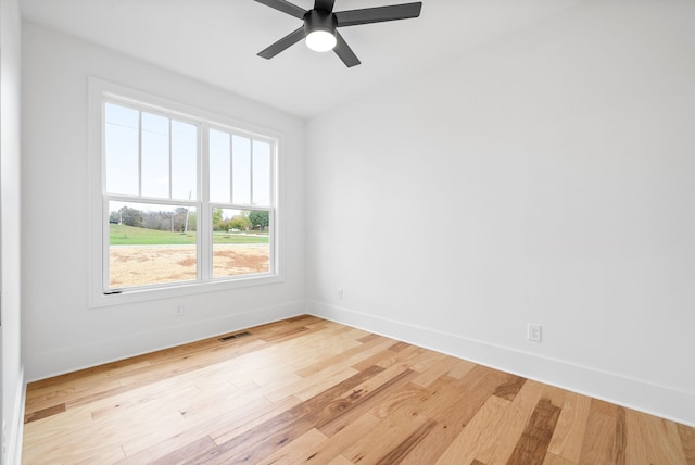 spare room featuring light hardwood / wood-style floors and ceiling fan