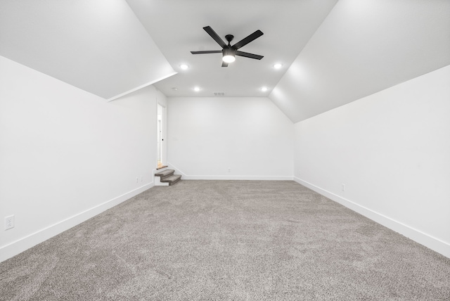 additional living space with carpet floors, ceiling fan, and vaulted ceiling