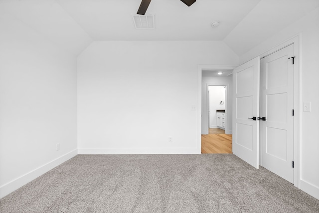 unfurnished bedroom with lofted ceiling, light colored carpet, and ceiling fan