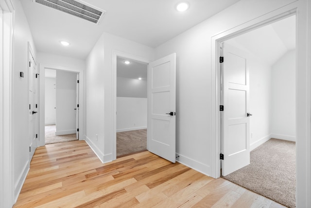 corridor with light hardwood / wood-style flooring