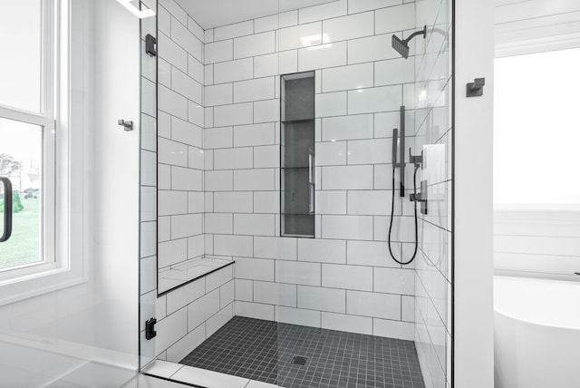 bathroom featuring separate shower and tub