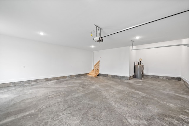 garage featuring water heater and a garage door opener