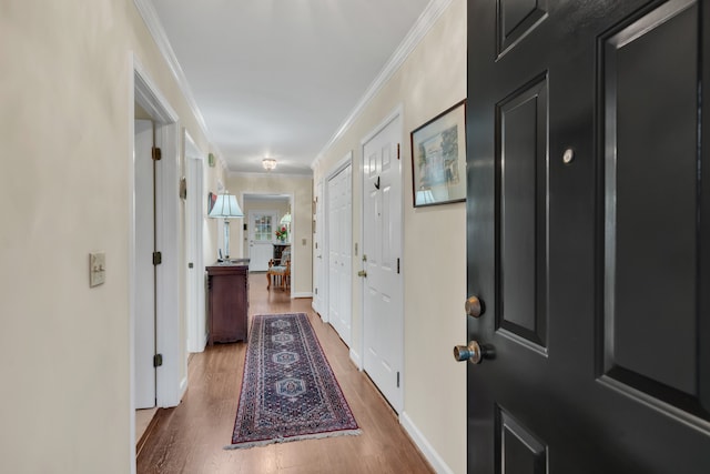 corridor featuring hardwood / wood-style flooring and ornamental molding