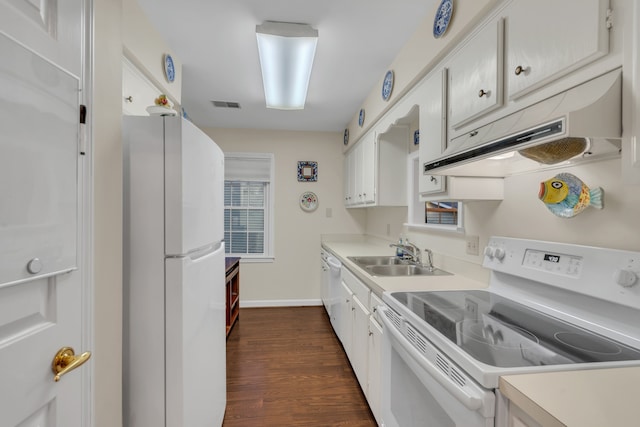 kitchen with white cabinets, dark hardwood / wood-style flooring, sink, and white appliances