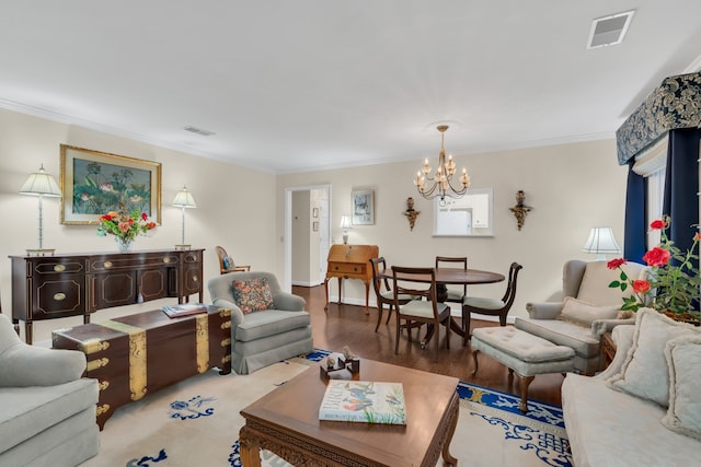 living room featuring ornamental molding, light hardwood / wood-style floors, and an inviting chandelier