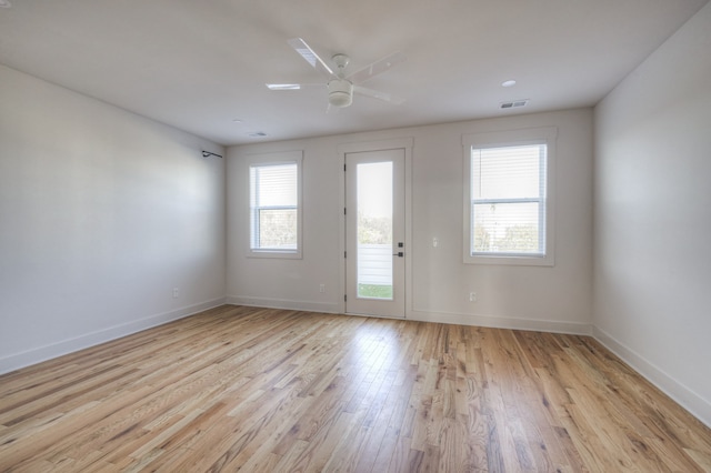 unfurnished room with light wood-type flooring and ceiling fan