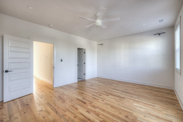 spare room with light hardwood / wood-style flooring and ceiling fan