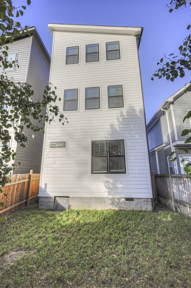 rear view of property featuring a yard