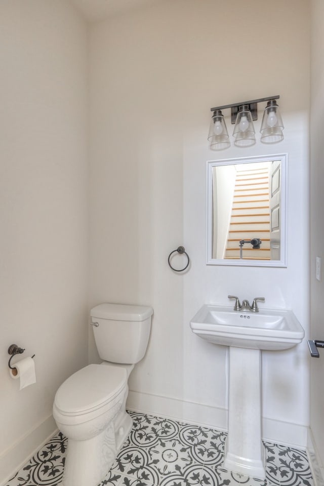 bathroom featuring tile patterned flooring and toilet