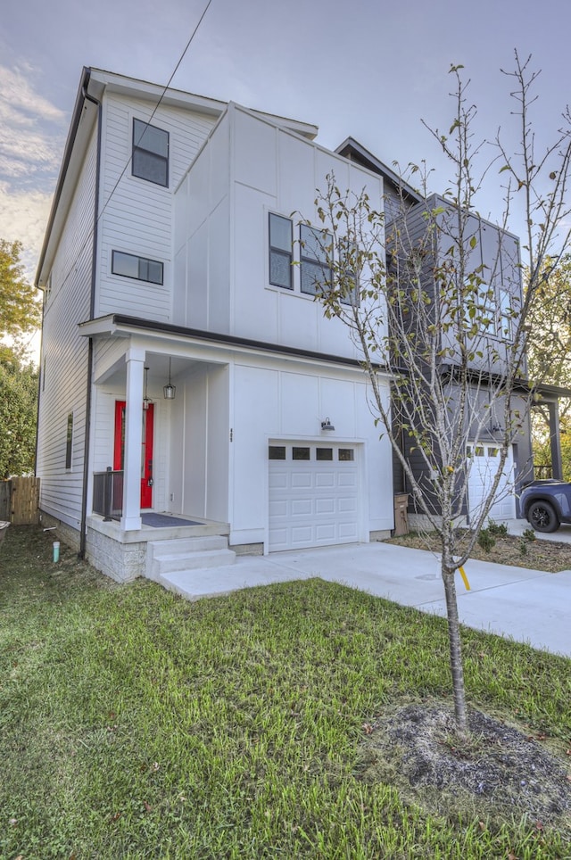 view of front of property featuring a garage and a front lawn