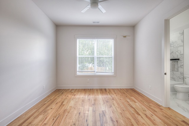 empty room featuring light hardwood / wood-style flooring and ceiling fan