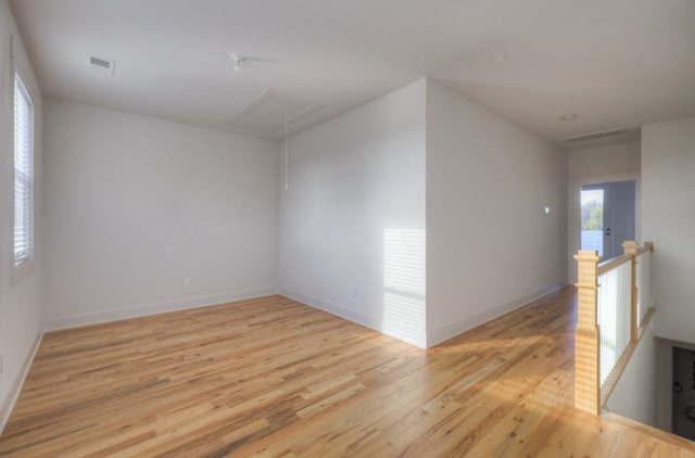 empty room with light hardwood / wood-style flooring