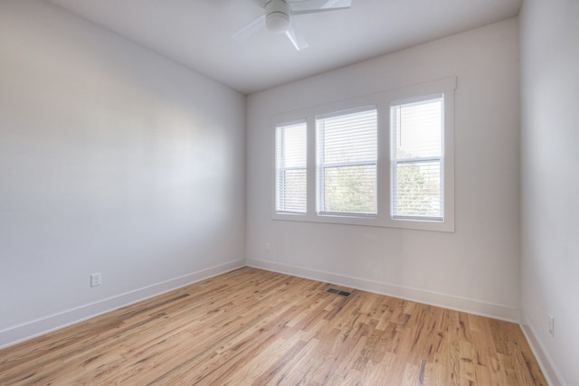 empty room featuring ceiling fan and light hardwood / wood-style floors