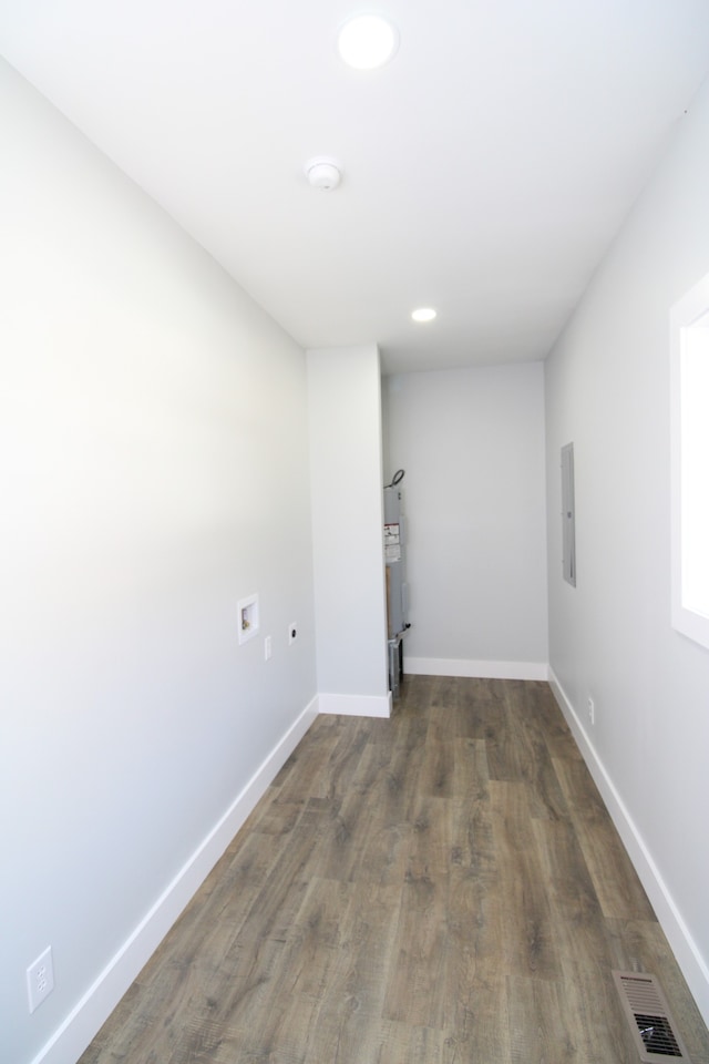 washroom featuring electric panel, hookup for a washing machine, and dark hardwood / wood-style floors