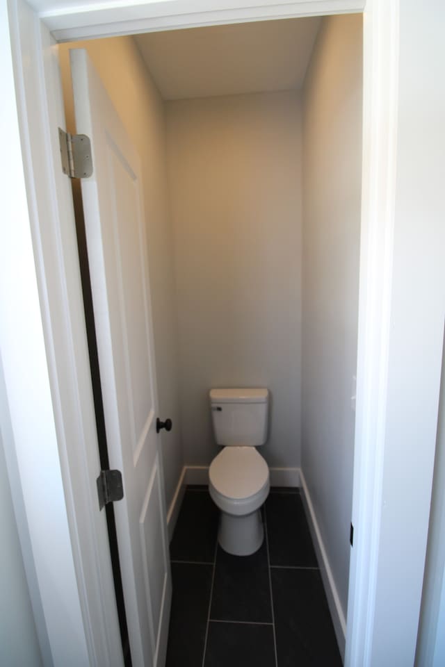 bathroom featuring toilet and tile patterned floors