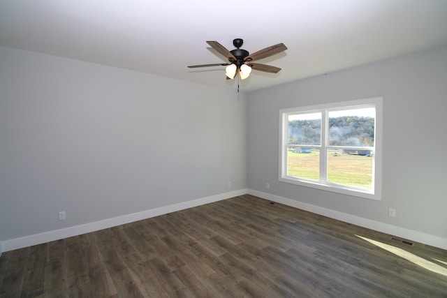 empty room with dark wood-type flooring and ceiling fan