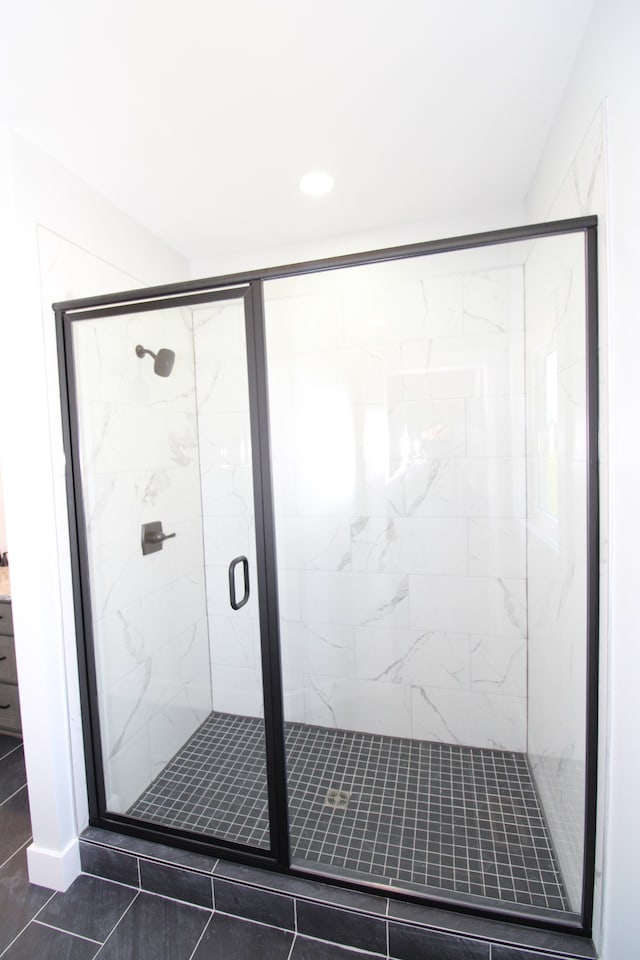 bathroom featuring walk in shower and tile patterned floors