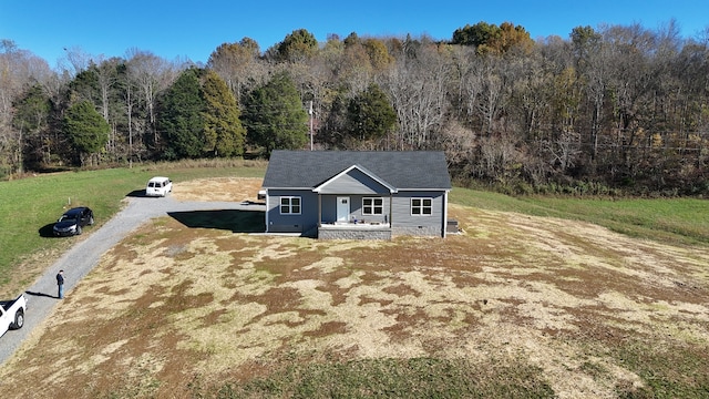 view of front of property with covered porch and a front lawn