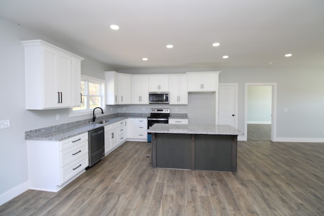 kitchen with a kitchen island, white cabinetry, sink, and stainless steel appliances