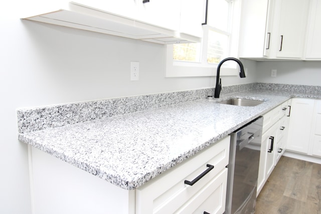 kitchen featuring dark hardwood / wood-style flooring, light stone counters, white cabinets, sink, and stainless steel dishwasher