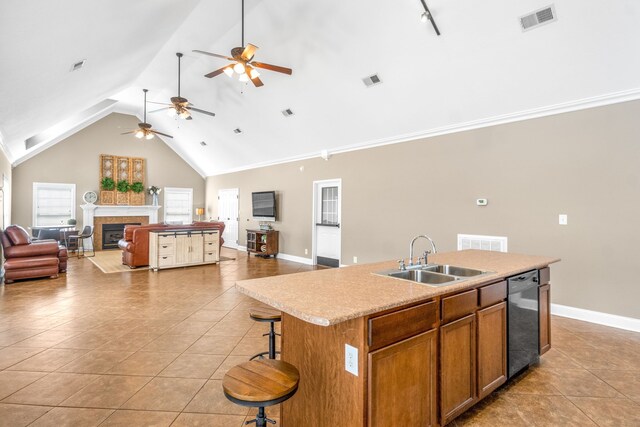 kitchen featuring dishwasher, high vaulted ceiling, sink, and a center island with sink