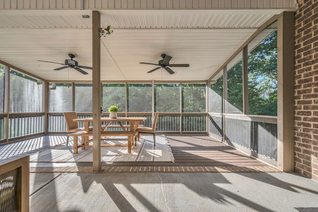 unfurnished sunroom featuring ceiling fan and a healthy amount of sunlight