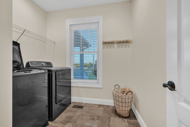 clothes washing area with washer and dryer