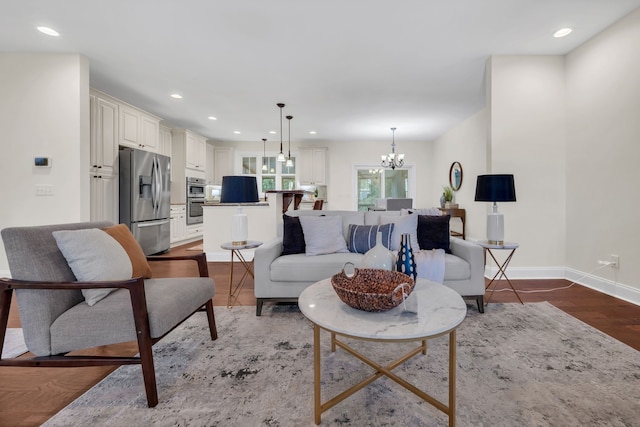 living room with wood-type flooring and a chandelier