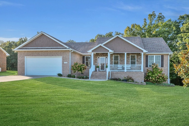 view of front of home featuring a porch, a front yard, and a garage