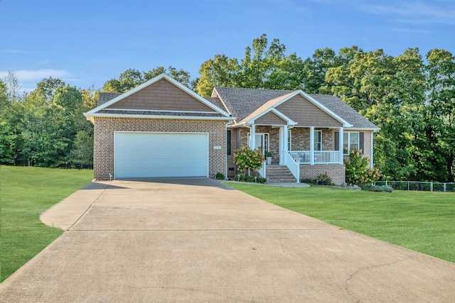 view of front of property featuring a garage, a porch, and a front yard