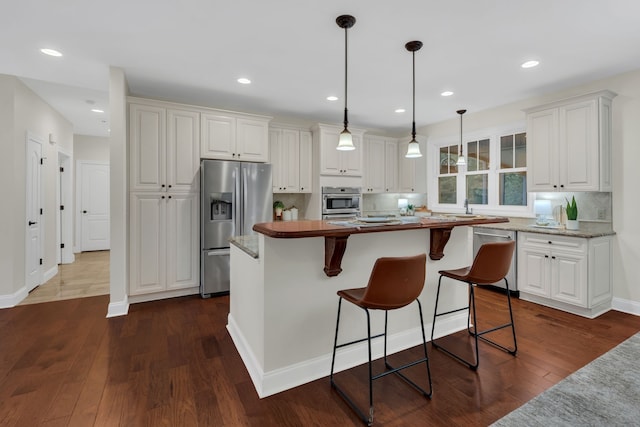 kitchen featuring dark wood-type flooring, white cabinets, and stainless steel appliances