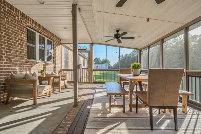 sunroom with wood ceiling, vaulted ceiling, and ceiling fan