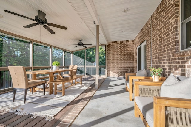 sunroom / solarium with beamed ceiling, wood ceiling, and ceiling fan