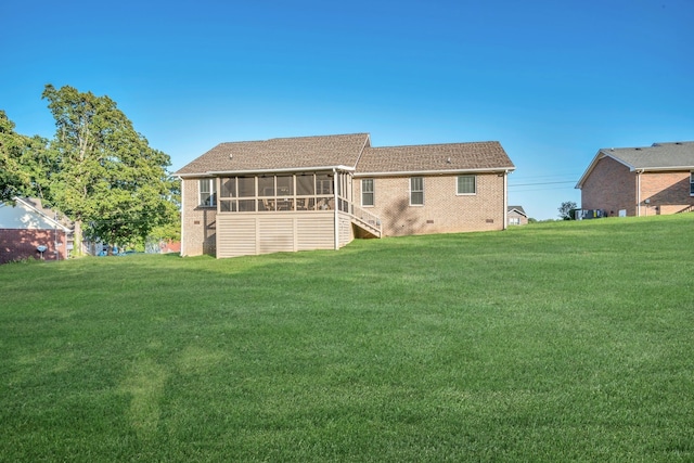 back of house with a lawn and a sunroom