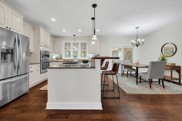 kitchen with dark wood-type flooring, white cabinetry, and appliances with stainless steel finishes