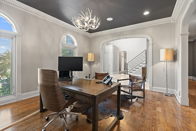 home office with hardwood / wood-style floors, a notable chandelier, and ornamental molding