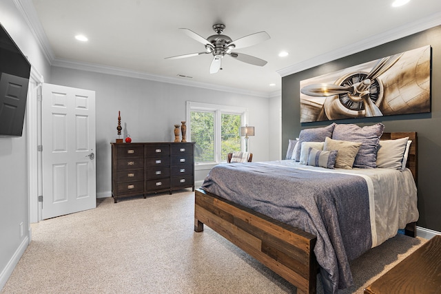 carpeted bedroom featuring ceiling fan and crown molding