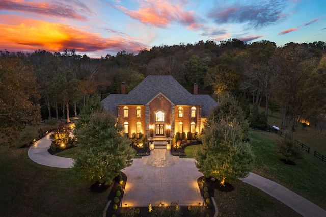 back house at dusk with a yard